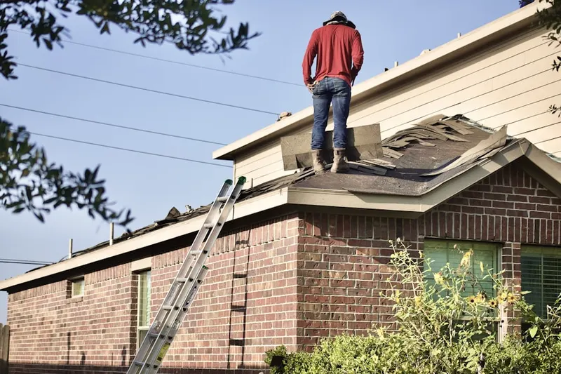Professional roofer working on a residential roof in Vantage